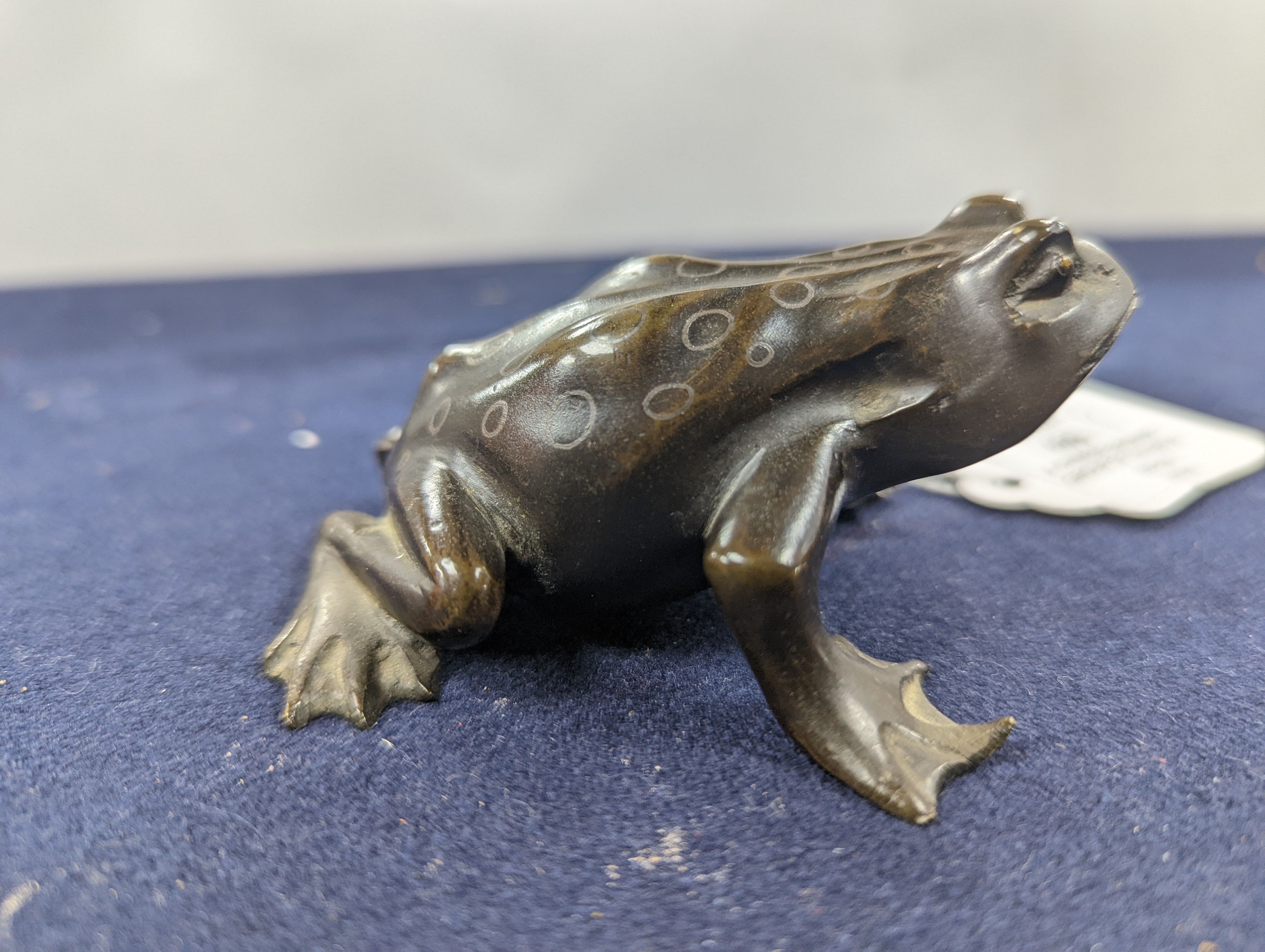A Chinese bronze group of Liu Hai and a toad, wood stand and a bronze figure of a dog, 9cm